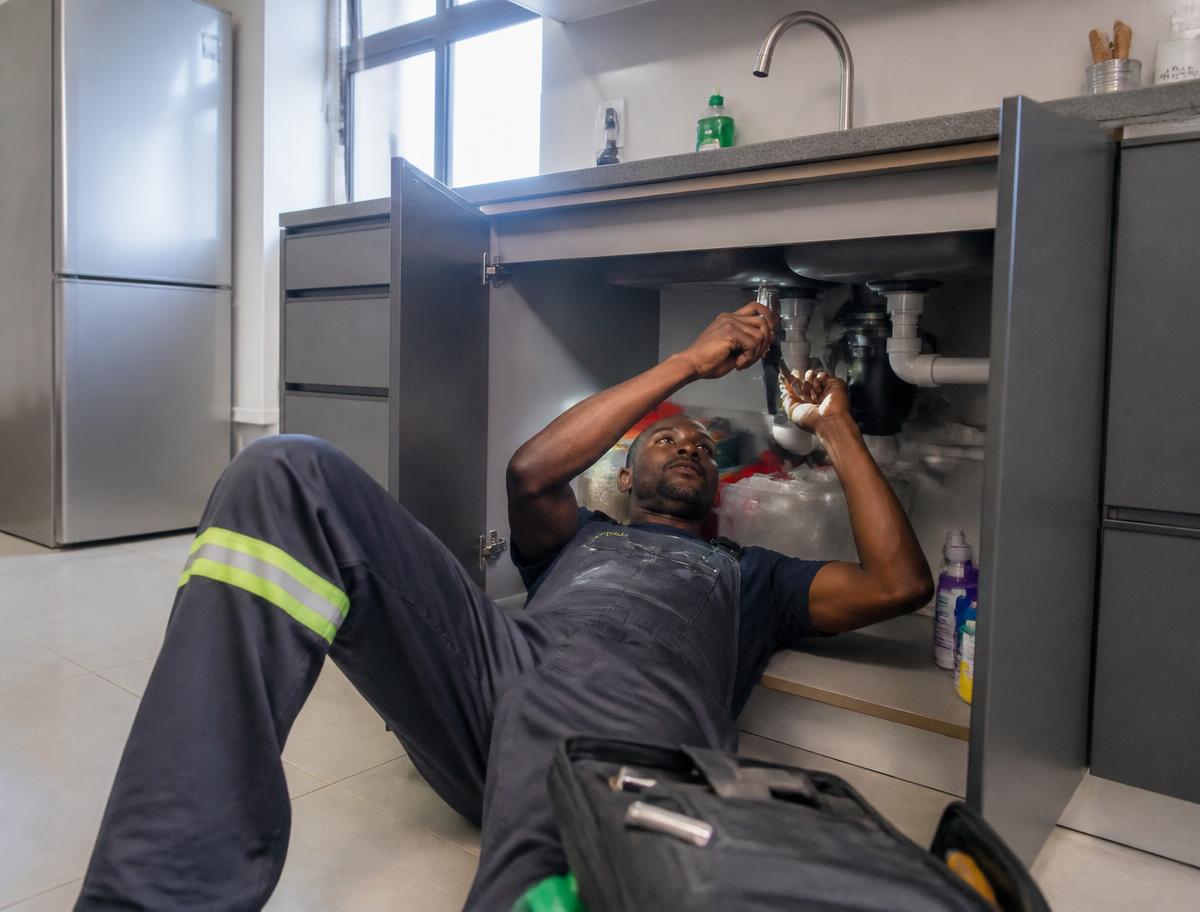 Plumbing professional at work in a South African property